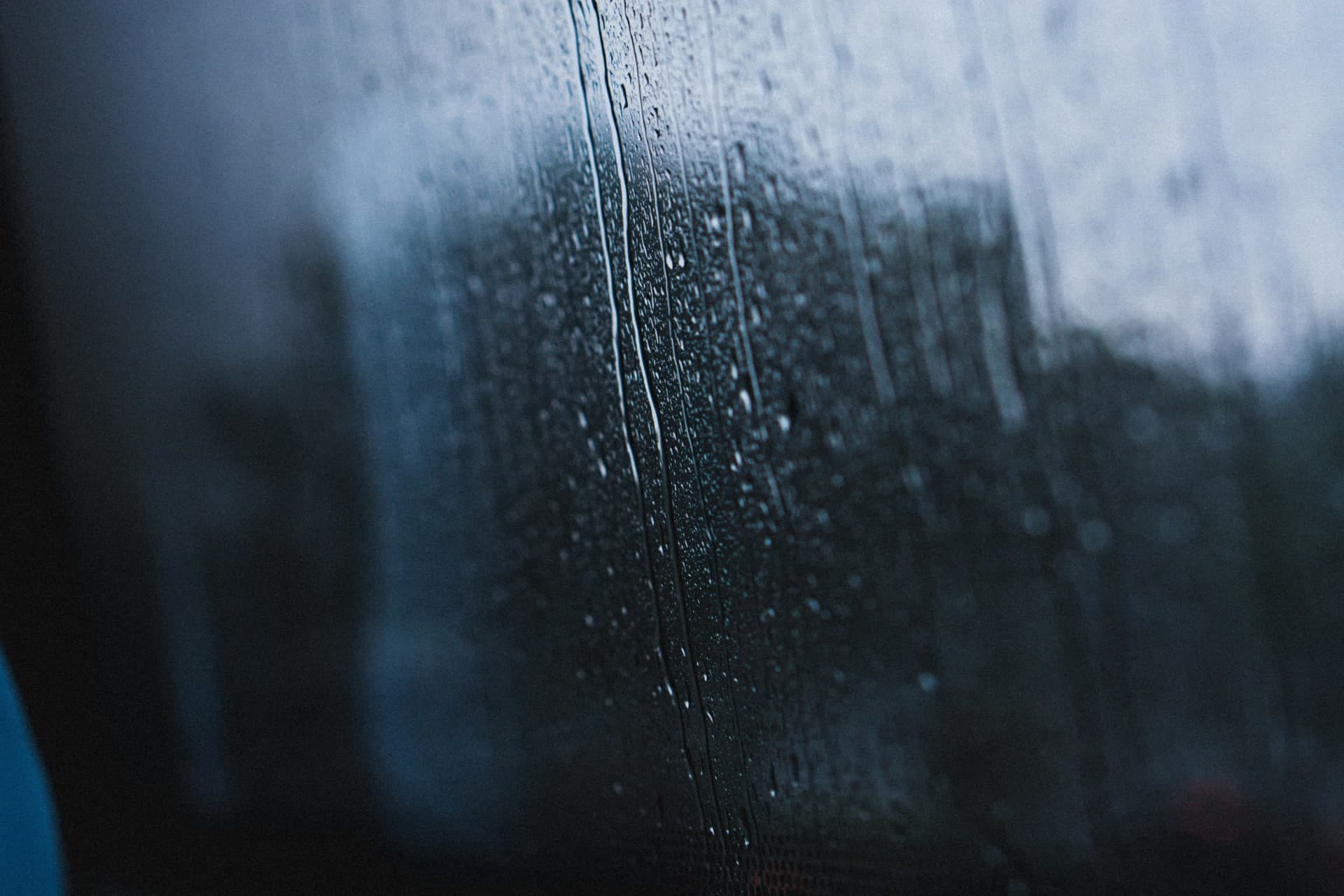 Rain and hail storm hitting window on Denver home — NexVue Exteriors hail damage replacement