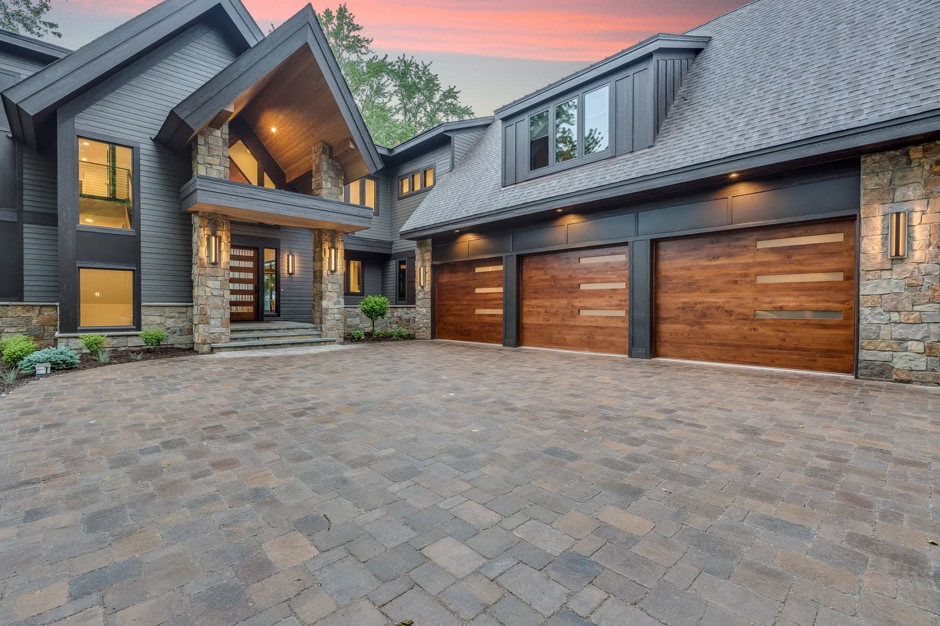 Wood garage door with stone house installed by NexVue Exteriors Denver